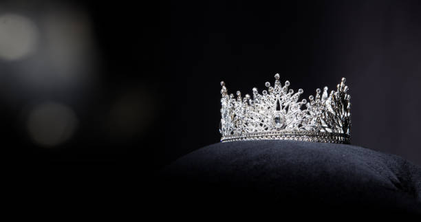 Diamond Silver Crown Miss Pageant Beauty Contest Diamond Silver Crown for Miss Pageant Beauty Contest, Crystal Tiara jewelry decorated gems stone and abstract dark background on black velvet fabric cloth, Macro photography copy space for text logo beauty pageant stock pictures, royalty-free photos & images