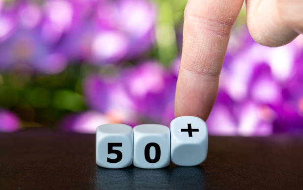 Dice form the expression 50+ as symbol for all people older than 50 years. stock photo