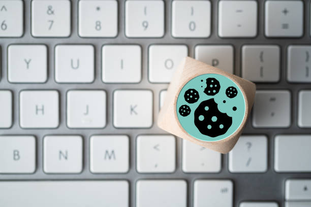 Dice with Cookie icons on a laptop keyboard conceptual of GDPR"n stock photo