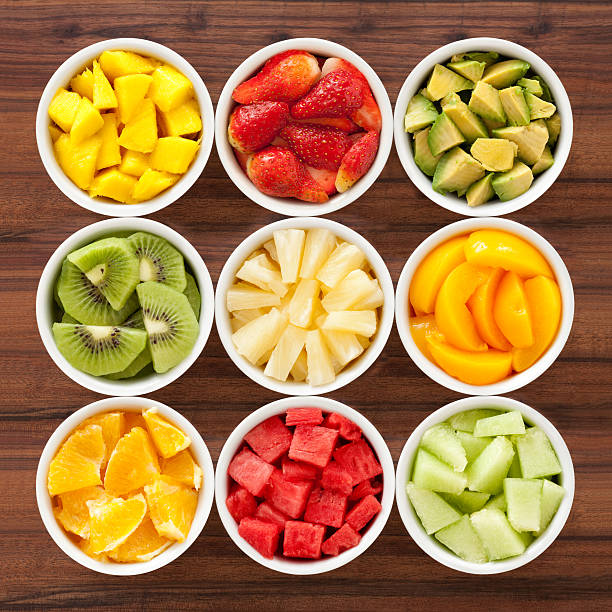diced fruits Nine bowls containing different types of chopped fruits chopped food stock pictures, royalty-free photos & images