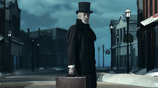 Dickens Scrooge Man in Old Winter Street. Holding Suitcase.