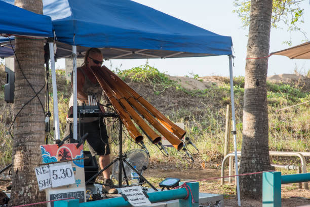 Didgeridoo Musician Darwin, Northern Territory, Australia-October 8,2017: Mindil Beach market with didgeridoo musician entertaining with sound equipment in Darwin, Australia tiktok stock pictures, royalty-free photos & images