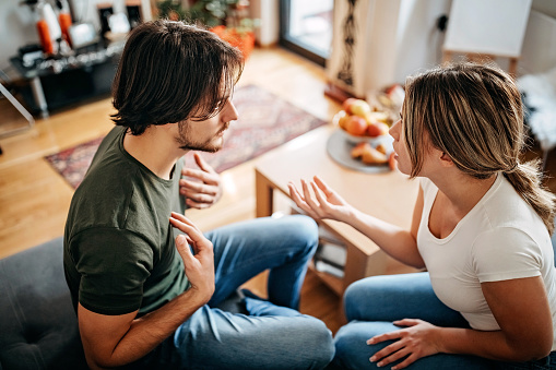 Couple have relationship issues, arguing and fighting in living room