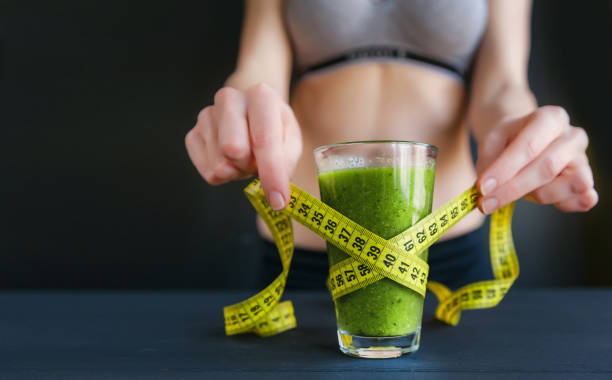 dietetic drink glass green. weight loss concept. natural light, dark background. stock photo