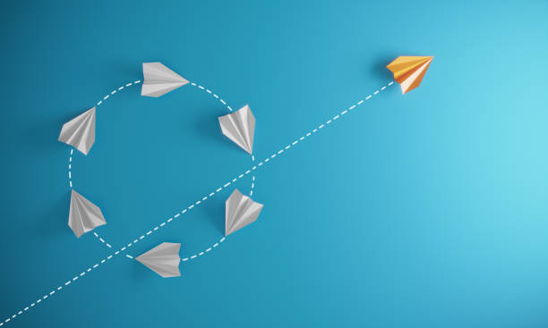 Different Approach - Different Direction Group of paper airplane in same one direction  and with one individual pointing in the different way, can be used leadership/individuality/innovation concepts.( 3d render ) concepts and ideas stock pictures, royalty-free photos & images