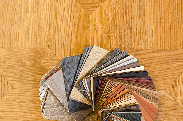 Different color samples of wood floor on brown parquet background. stock photo