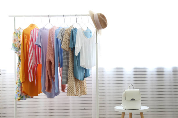 different colorful casual clothing hanging in row. - clothes wardrobe imagens e fotografias de stock