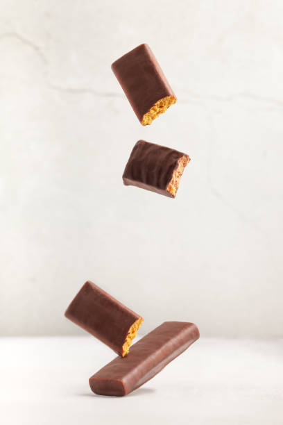 Different energy protein bar on grey background. Flying levitation stock photo