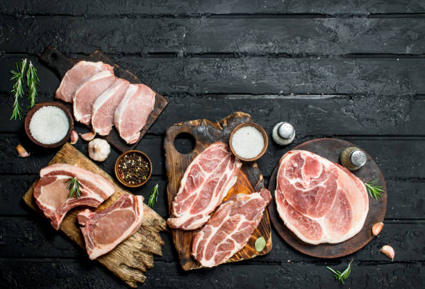 Different kinds of pork meat with spices. stock photo