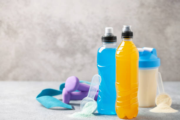 Different sport drinks in bottles - L-carnitine, isotonic and protein shake. Fitness concept. stock photo