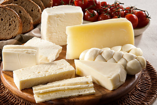 different types of cheese, bread and tomatoes - kaas stockfoto's en -beelden