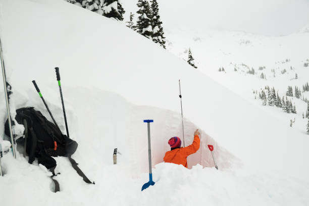 i̇stikrar test etmek için bir kar çukur kazma - avalanche stok fotoğraflar ve resimler