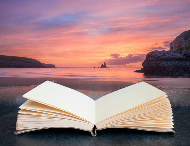 Digital composite image of Beautiful sunrise landscape of idyllic Broadhaven Bay beach on Pembrokeshire Coast in pages of imaginary open reading book stock photo