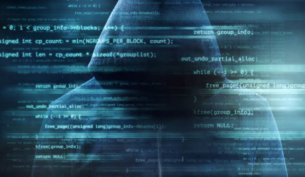 Digitally enhanced shot of computer code superimposed over an unrecognizable man in a hoodie stock photo