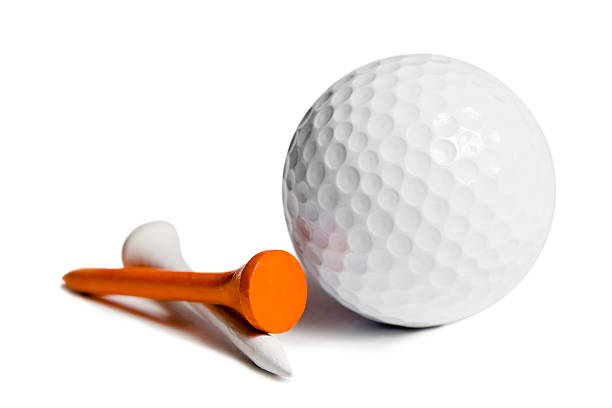 Dimpled golf ball and two tees on a white background "Golf ball and two wooden tees, one white, one orange. Isolated on white." golf ball stock pictures, royalty-free photos & images