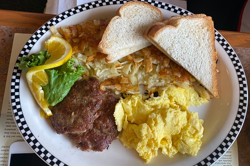 Link sausage with scrambled eggs, hash browns and toast