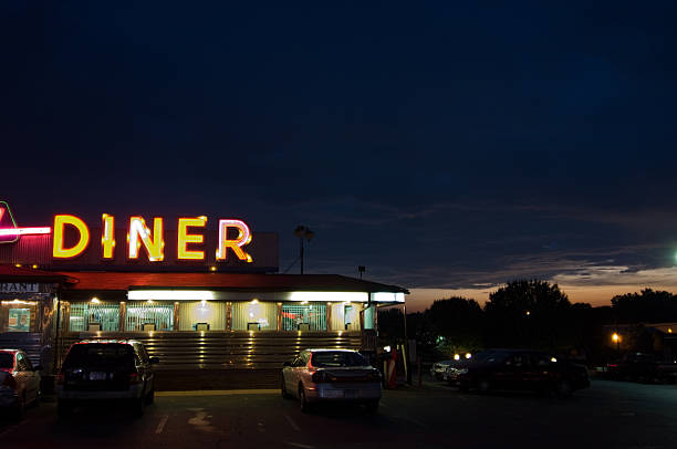 A diner sign lit up at night with cars parked Diner at dusk diner stock pictures, royalty-free photos & images