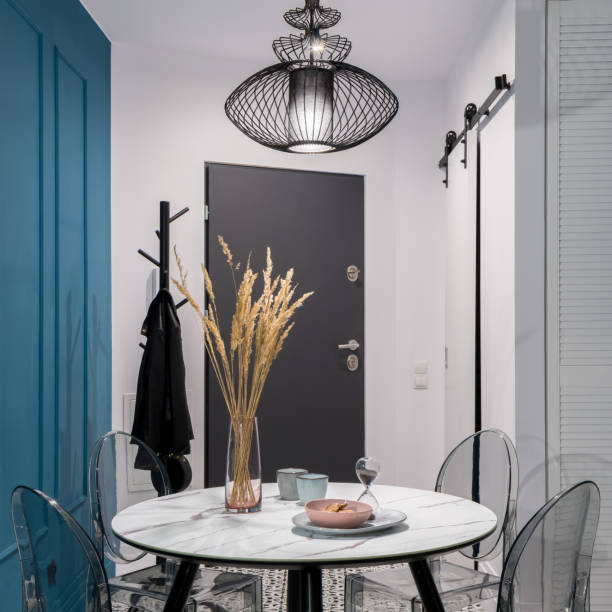 Dining area with entryway view in a black and teal theme