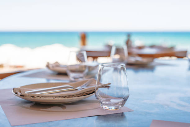 Dining table on the beach Dining table on the beach waterfront stock pictures, royalty-free photos & images
