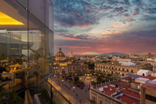 Dinner at a restaurant in a trendy hotel overlooking scenic panoramic view of the main Guadalajara square and Guadalajara Cathedral and city skyline stock photo
