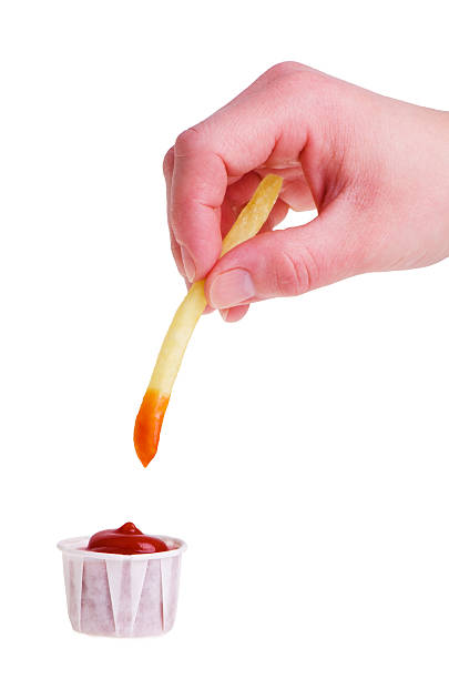 Dipping french fry stock photo