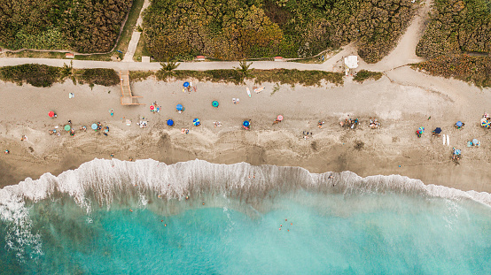 Aerial Views of Colorful Beach Umbrellas on Jupiter Beach, Florida at Mid-Day During COVID-19 in April of 2021
