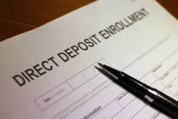 Direct Deposit Enrollment Form Someone filling out Direct Deposit Enrollment Form. bank deposit slip stock pictures, royalty-free photos & images