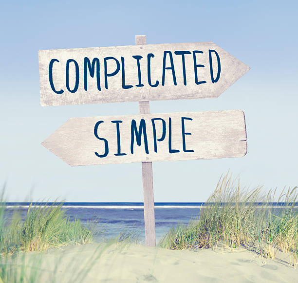 direction label on beach with complicated and simple text - strandbordjes stockfoto's en -beelden