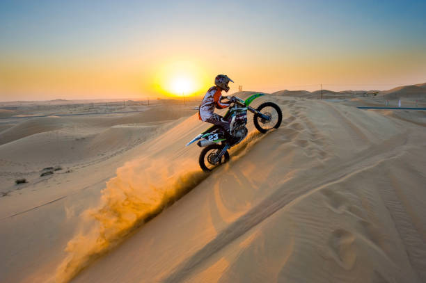 Dirt biking in desert stock photo