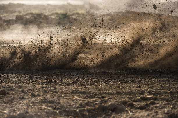 dirt fly after motocross roaring by - terra imagens e fotografias de stock