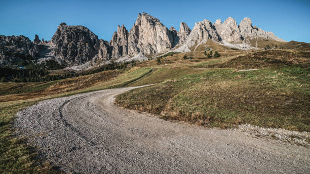 Dirt Road and Hiking Trail Track in Dolomite Italy Dirt road and hiking trail track in Dolomites mountain, Italy, in front of Pizes de Cir Ridge mountain ranges in Bolzano, South Tyrol, Northwestern Dolomites, Italy. dirt road stock pictures, royalty-free photos & images