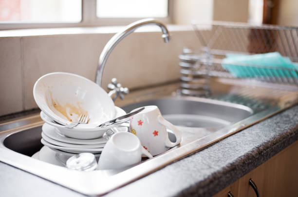 Dirty dishes in the sink Shot of kitchen sink full of dirty dishes crockery stock pictures, royalty-free photos & images