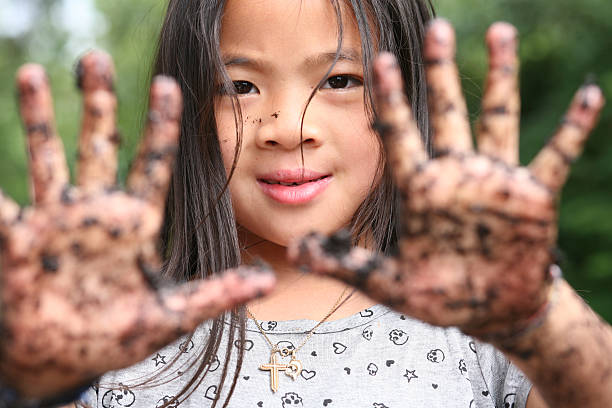 dirty hands child  showing two dirty hands, focus on the eys - hands out of focus mud stock pictures, royalty-free photos & images