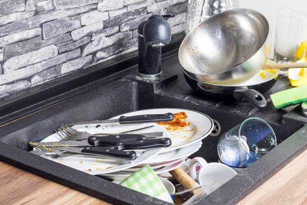 Dirty kitchenware in the sink. stock photo