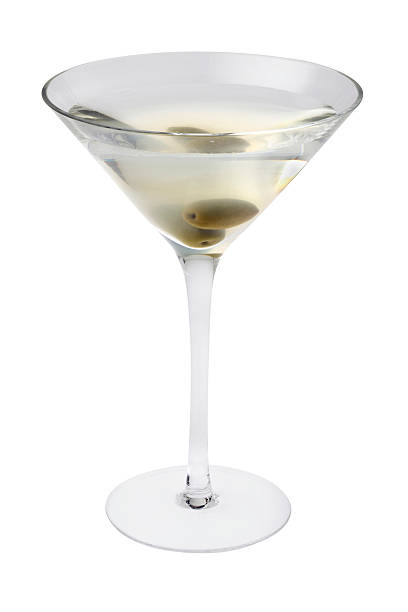 Dirty Martini cocktail Dirty Martini mixed drink with olive garnish close up on a white background dirty martini stock pictures, royalty-free photos & images