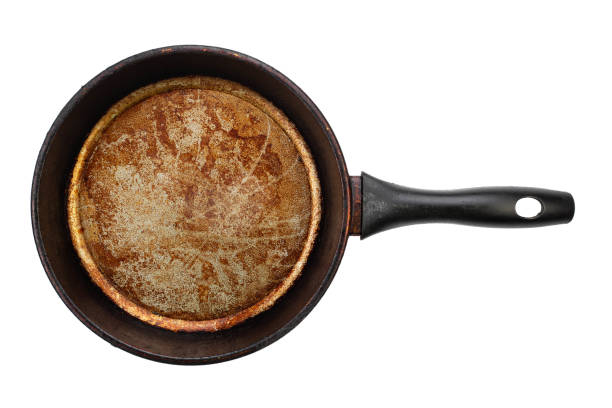 Dirty old frying pan on white background. File contains clipping path. stock photo
