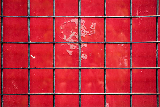 Dirty red window with grey grid stock photo