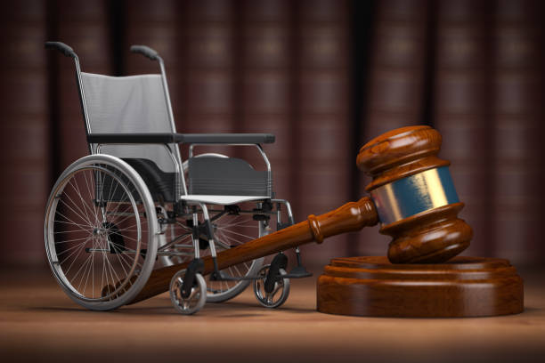 Disability law and social services for disabled people concept. Wheelchair and gavel. stock photo