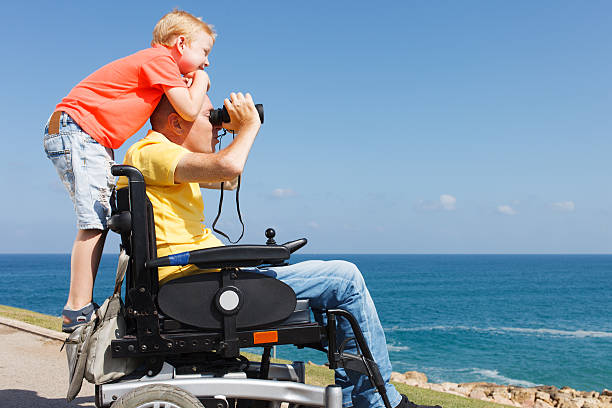 Disabled father and son play with Binocular stock photo