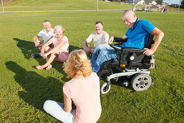 Disabled Man with family outside. stock photo