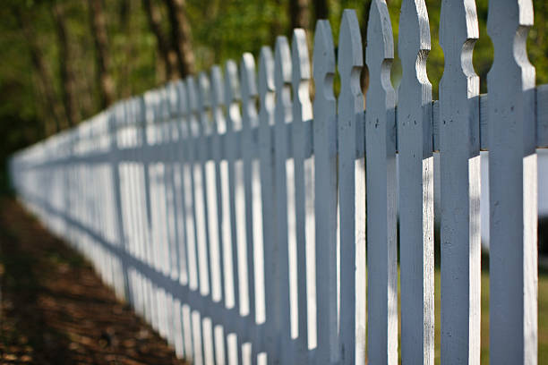 disappearing white picket fence stock photo
