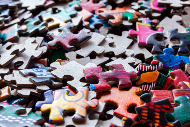 Disassembled puzzle colored pieces stock photo