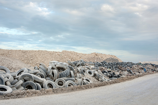 Hundreds of sand covered tyres left by the roadside.