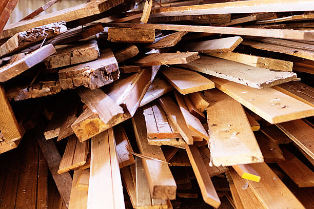 Discarded wooden planks piled high: recycling or construction theme stock photo