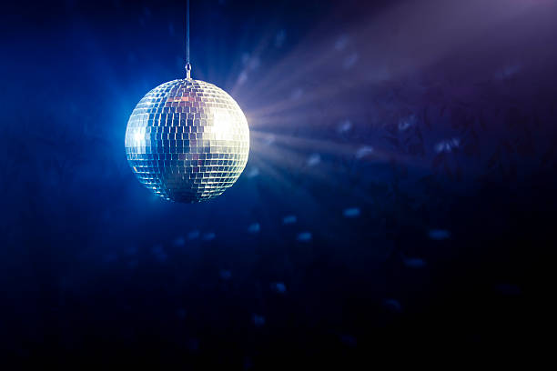 Disco ball with light rays Photo of a shinny disco ball disco ball stock pictures, royalty-free photos & images