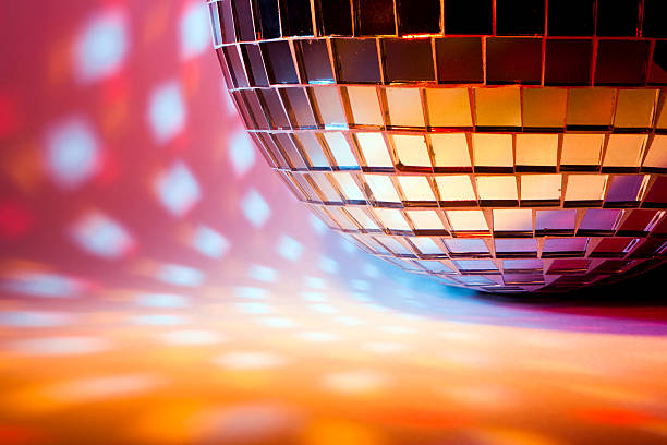 Disco sphere with colored spot lights A mirror ball with colored reflection spots. Nice background disco dancing stock pictures, royalty-free photos & images