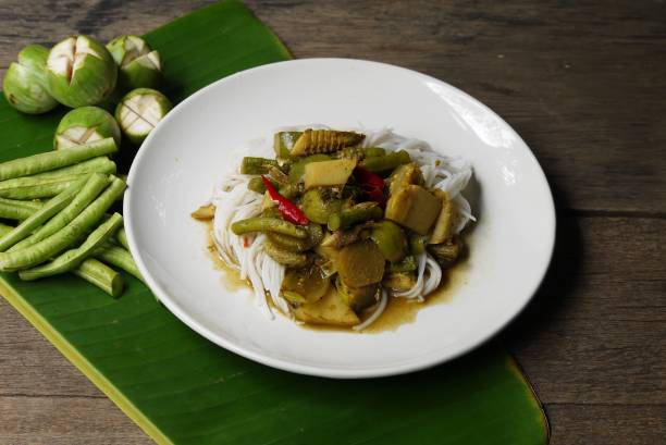 Dish of Fish organs sour soup  and Rice Noodles on banana leaf  with vegetables  in the kitchen prepare for serving ,Thai local food image for background , selective stock photo