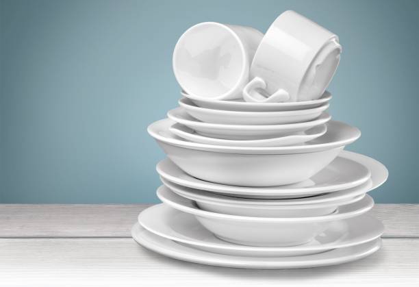 Dishware. Clean plates and cups isolated on background crockery stock pictures, royalty-free photos & images