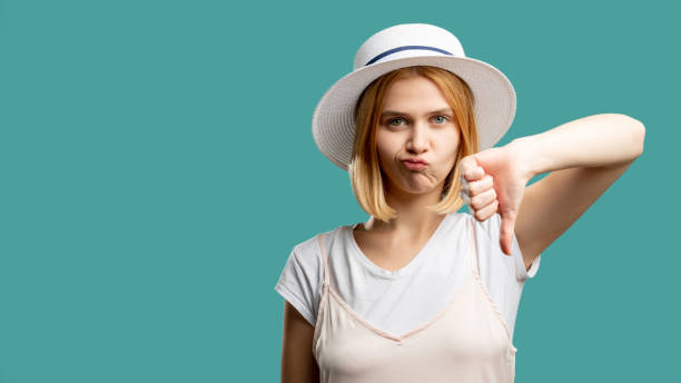 dislike gesture bad service disappointed woman stock photo