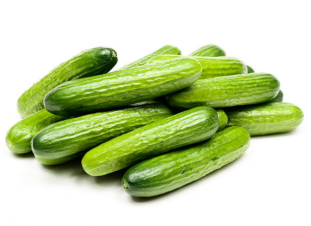 Display of small green cucumbers stock photo